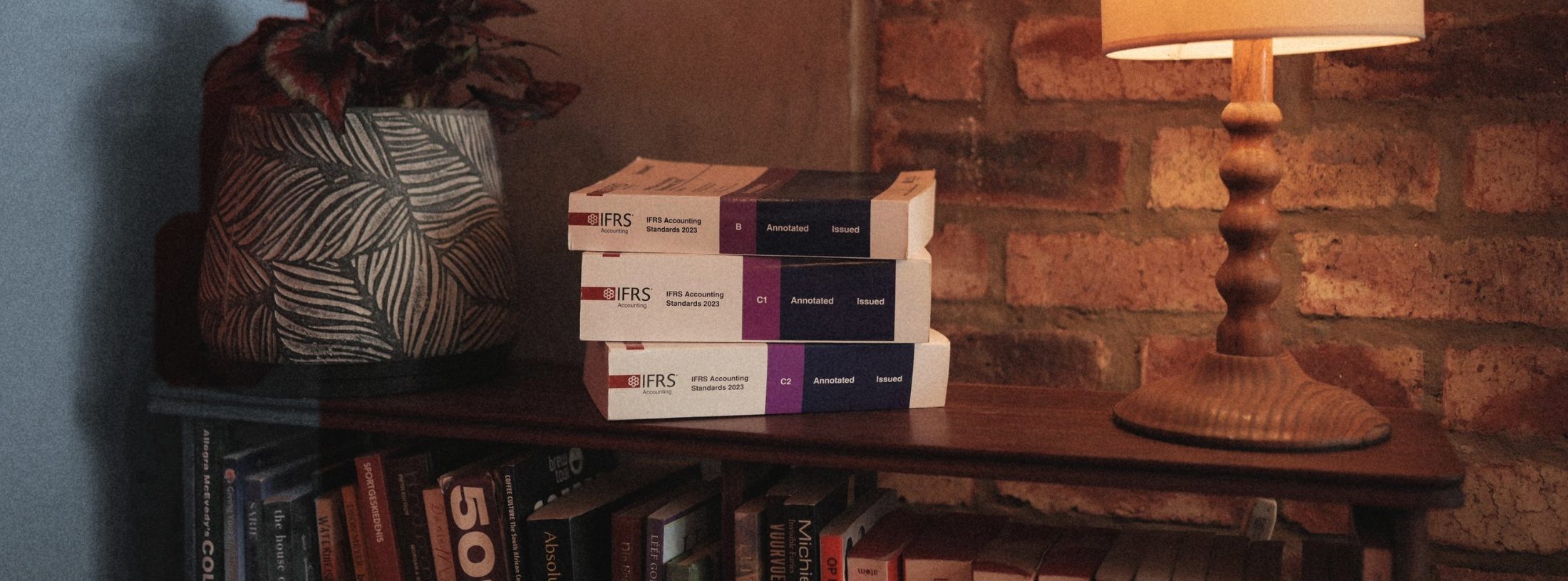 IFRS Accounting Standards reference volumes on a bookshelf